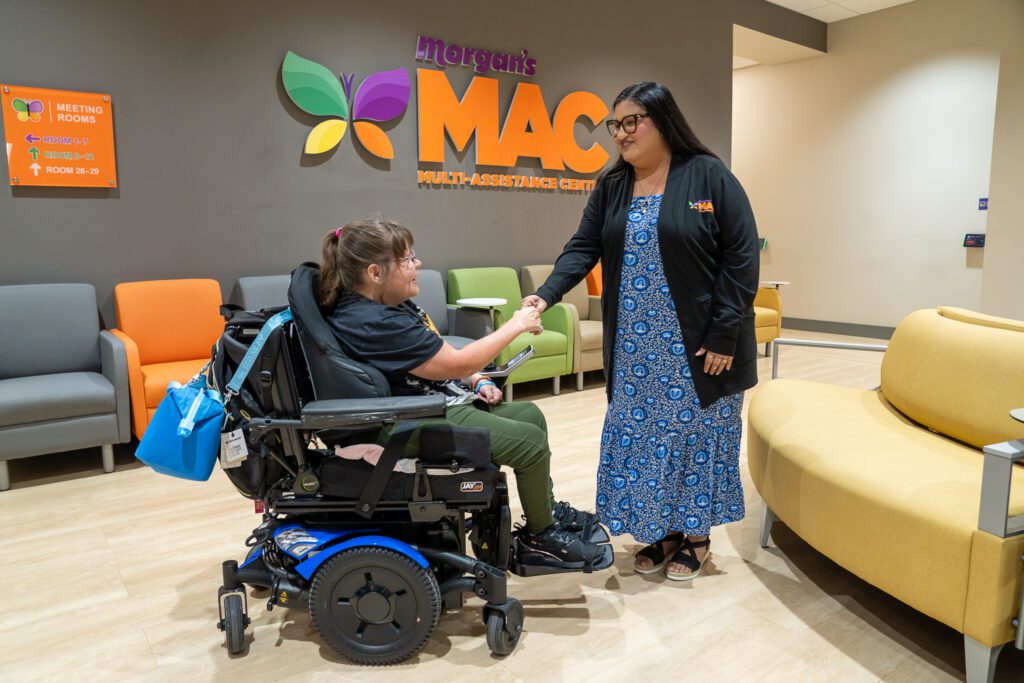 A Morgan's MAC navigator greets a member in the Multi-Assistance Center, beginning a personalized support journey.