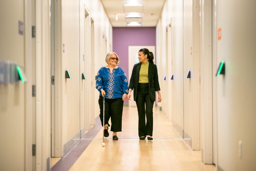 A Morgan's MAC team member walks alongside a member through the Multi-Assistance Center, providing personalized support.
